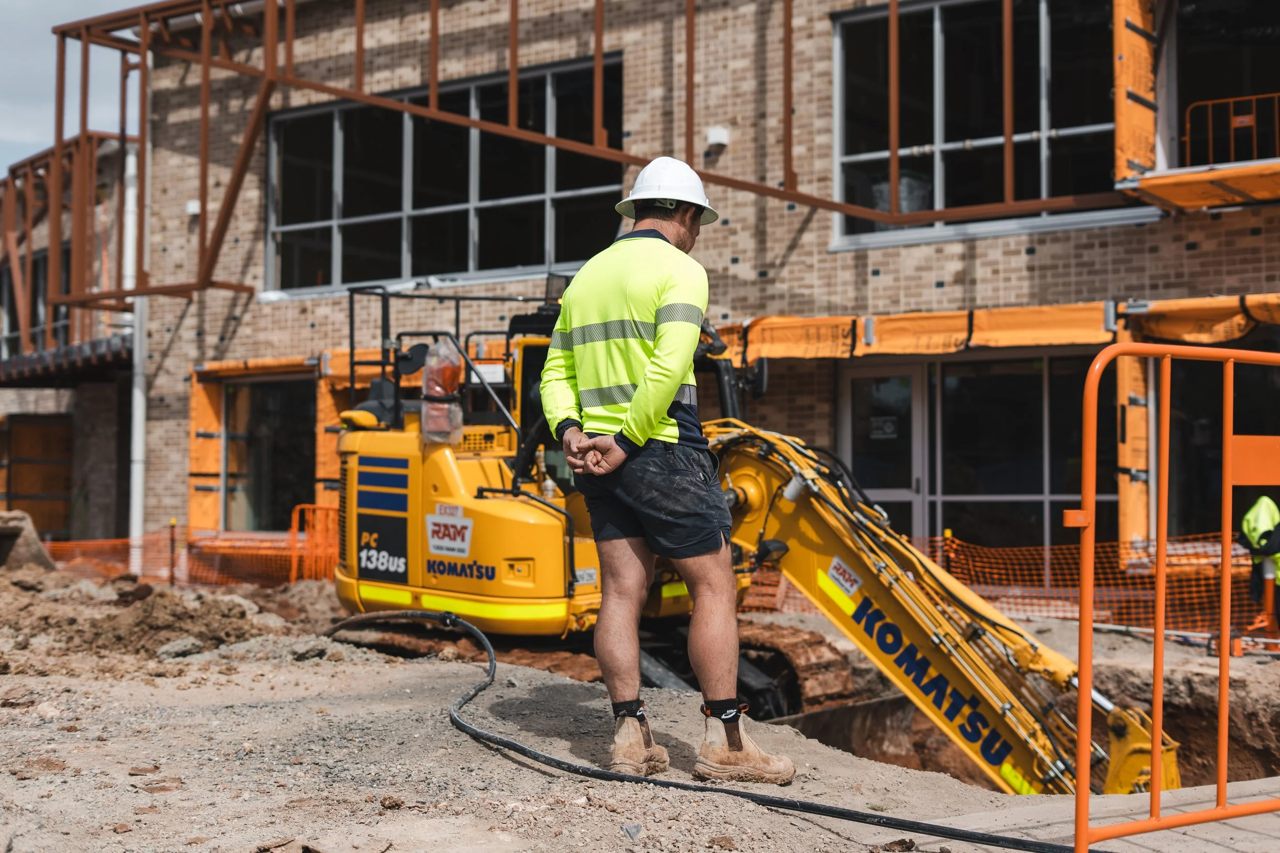 construction worker observing excavation work