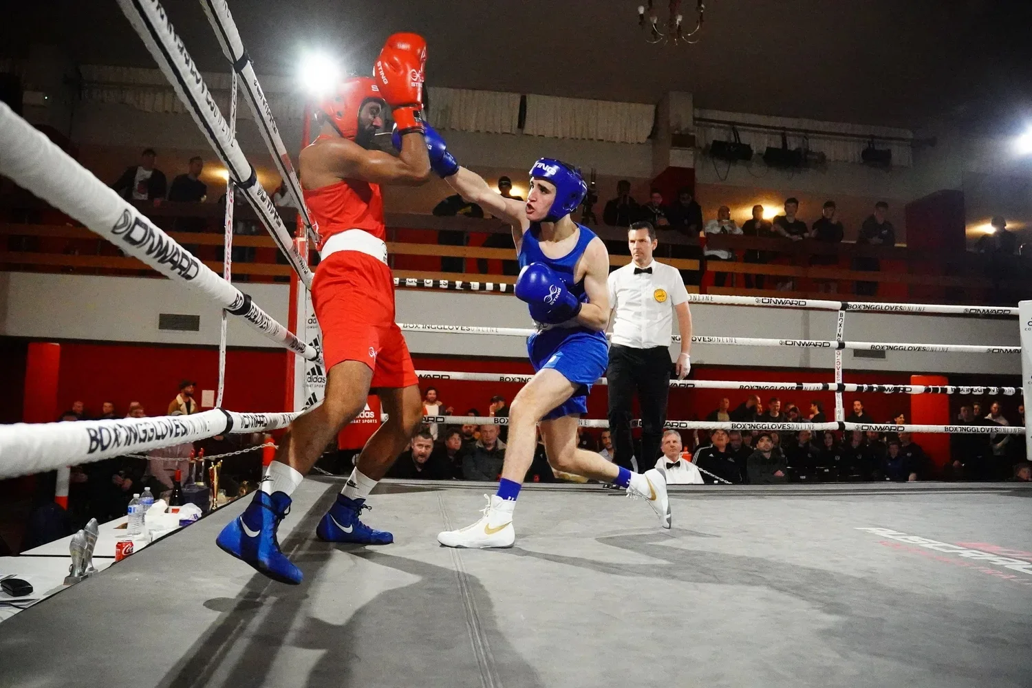 two boxers fighting with one boxer throwing a punch at the other