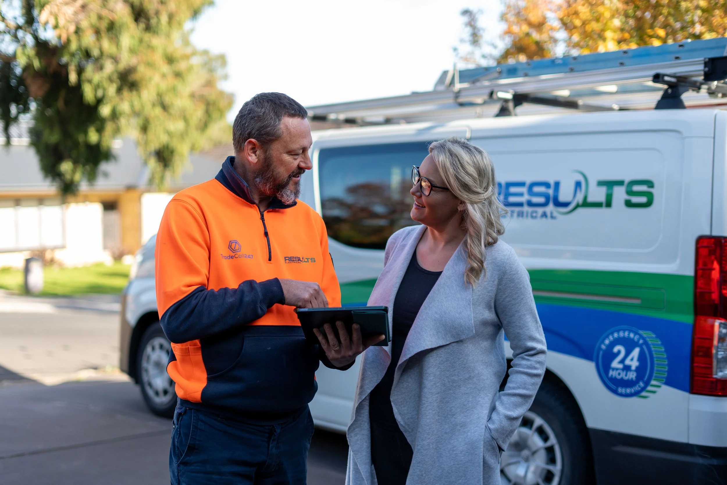 electrical standing with a client talking