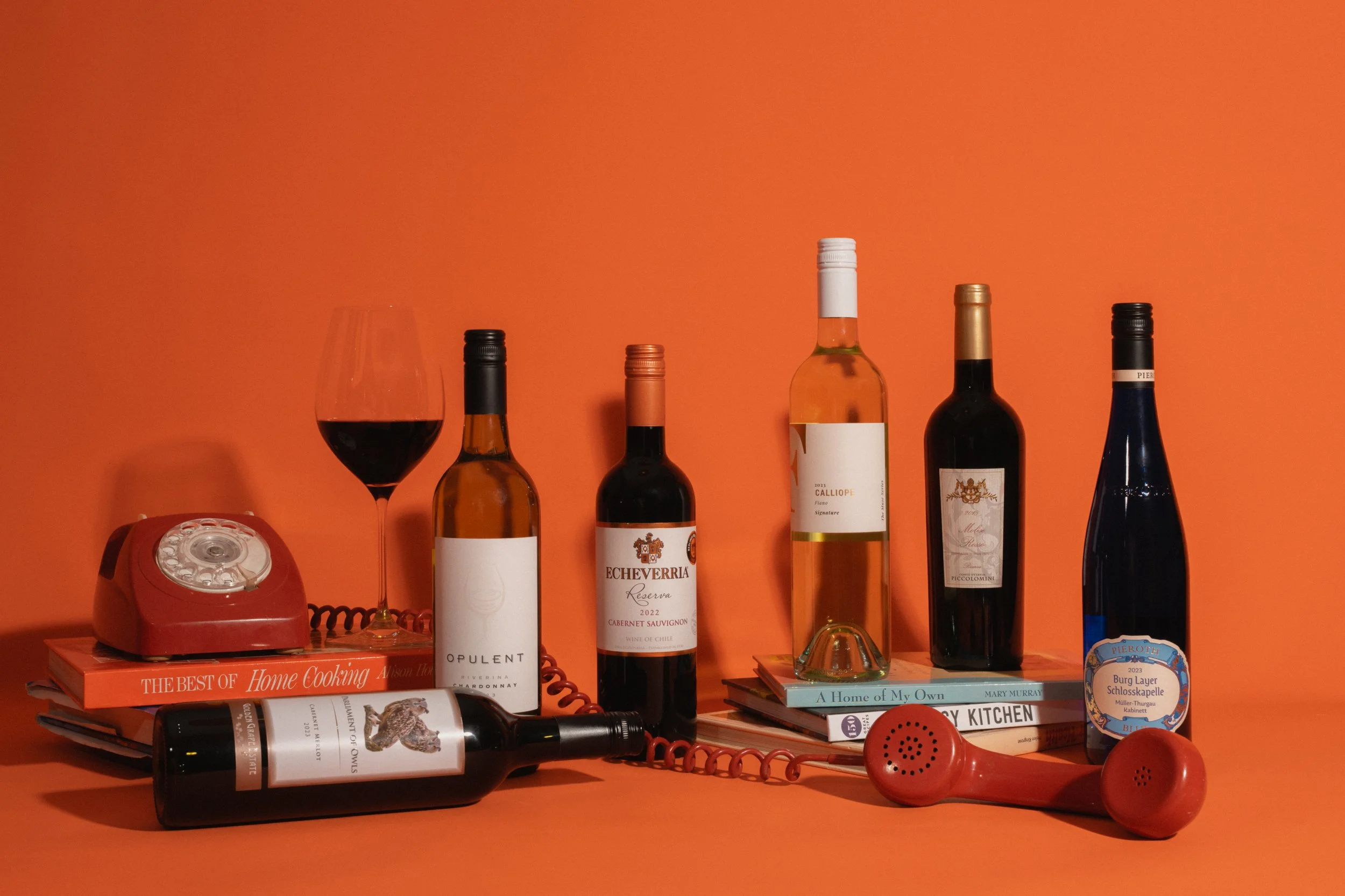 A promotional photo of wine bottles and a glass of red wine