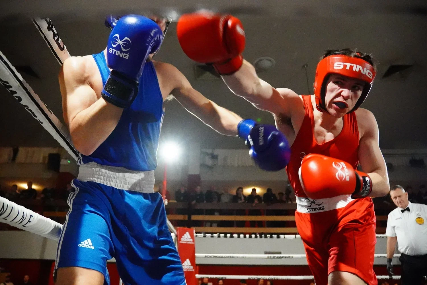 two boxers fighting with one boxer throwing a punch at the other
