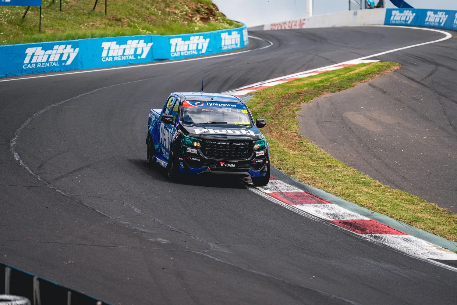 a V8 SuperUte Series race ute racing at a Bathurst race event.