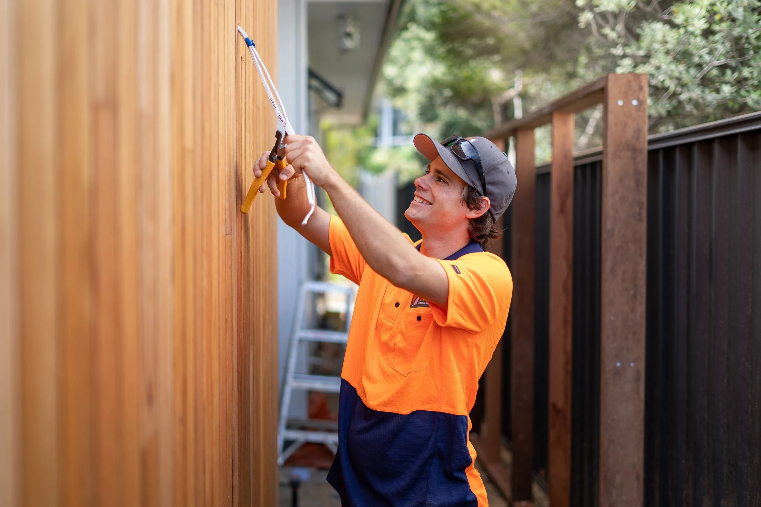 Electrician cutting wires at a clients home