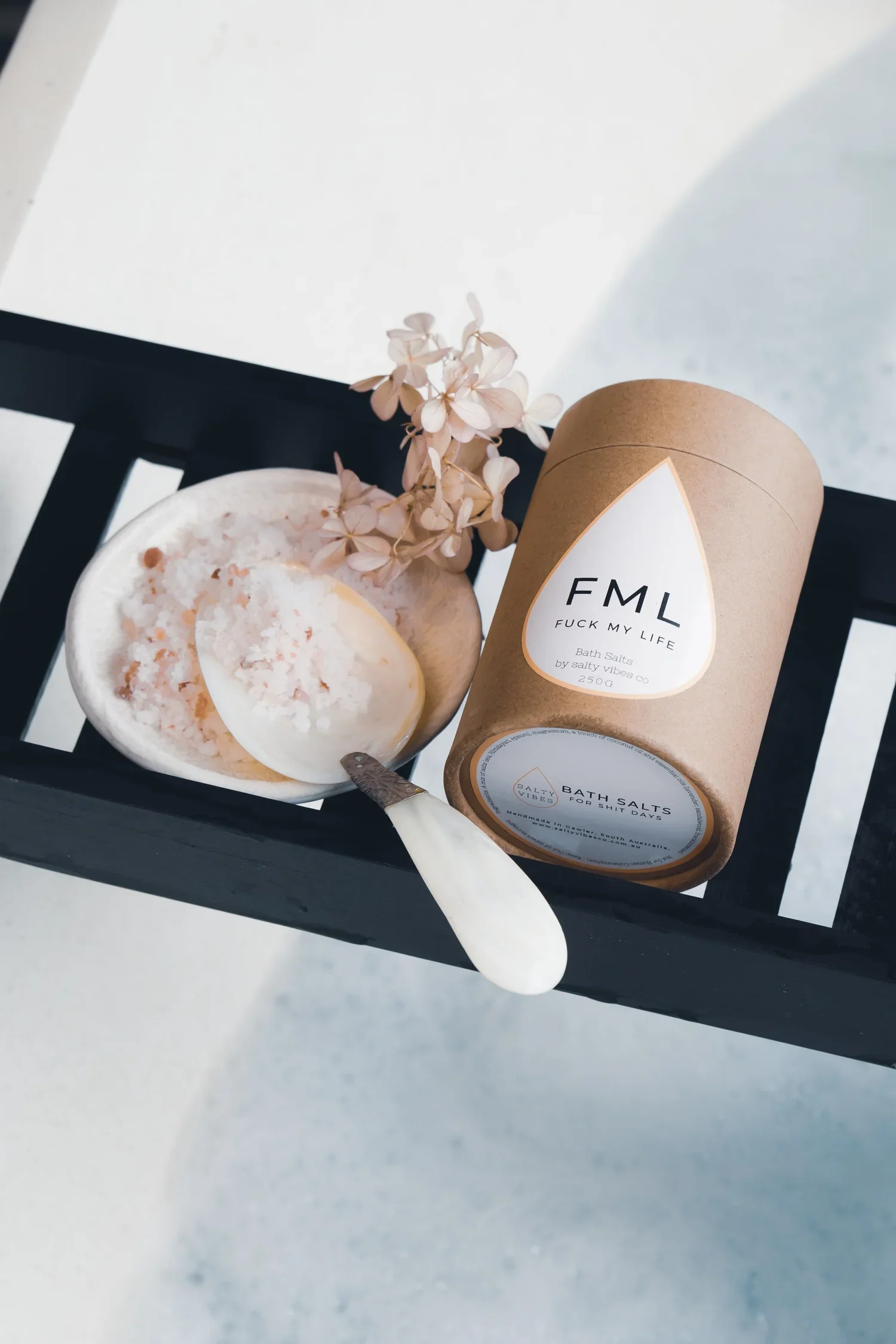 a promotional photo of bath salt on a bath shelf