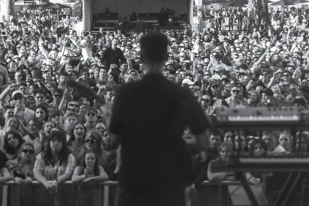 The Wombats frontman, Matthew "Murph" Murphy signing  and playing guitar in front of a large crowd at a music festival in McLaren Vale, South Australia