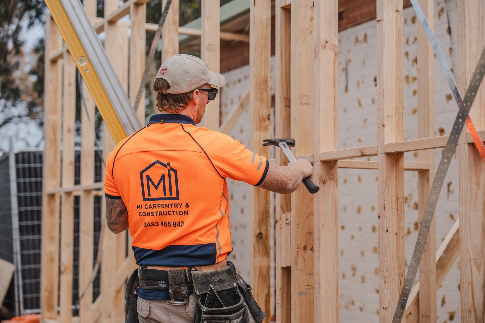 carpenter building a timber frame room