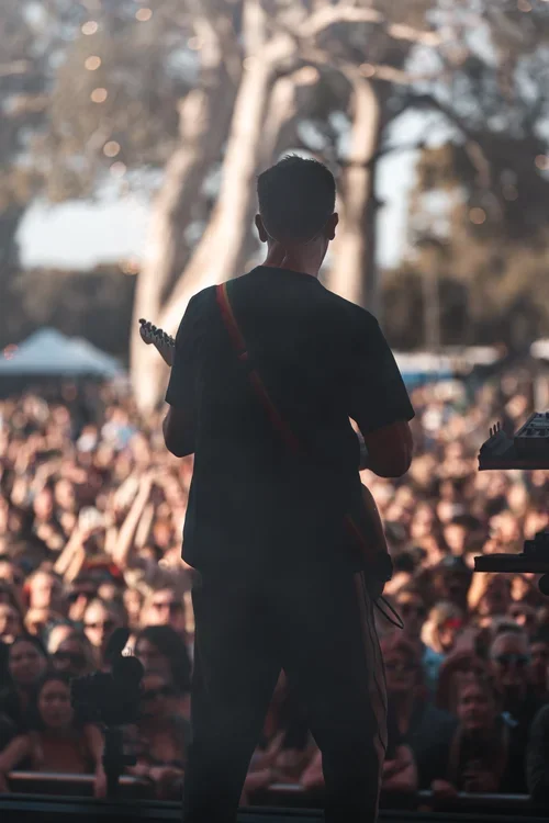 The Wombats frontman, Matthew "Murph" Murphy signing  and playing guitar in front of a large crowd at a music festival in McLaren Vale, South Australia