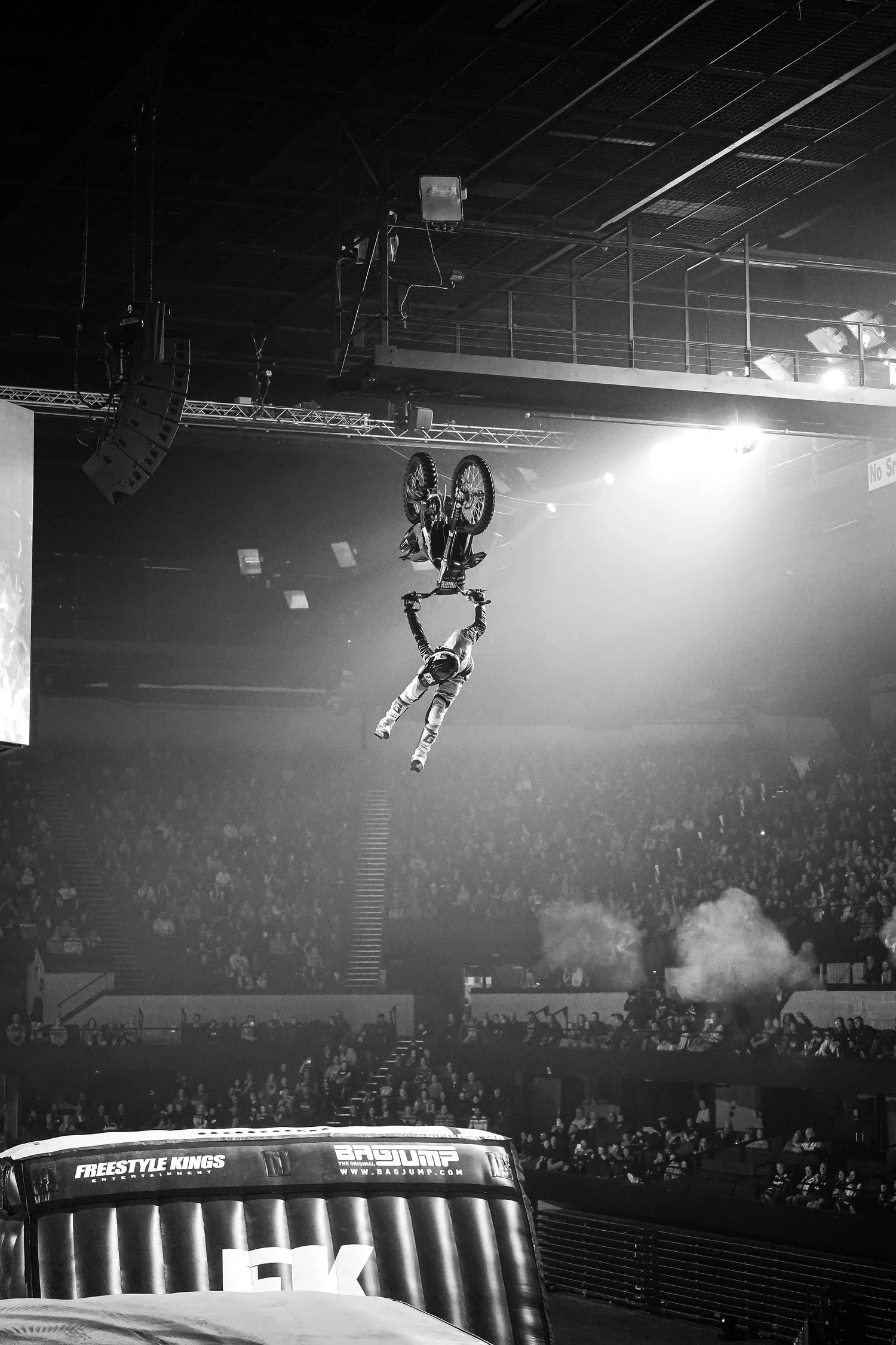 Professional Freestyle MX rider performing a backflip after jumping a ramp at a Freestyle Kings event