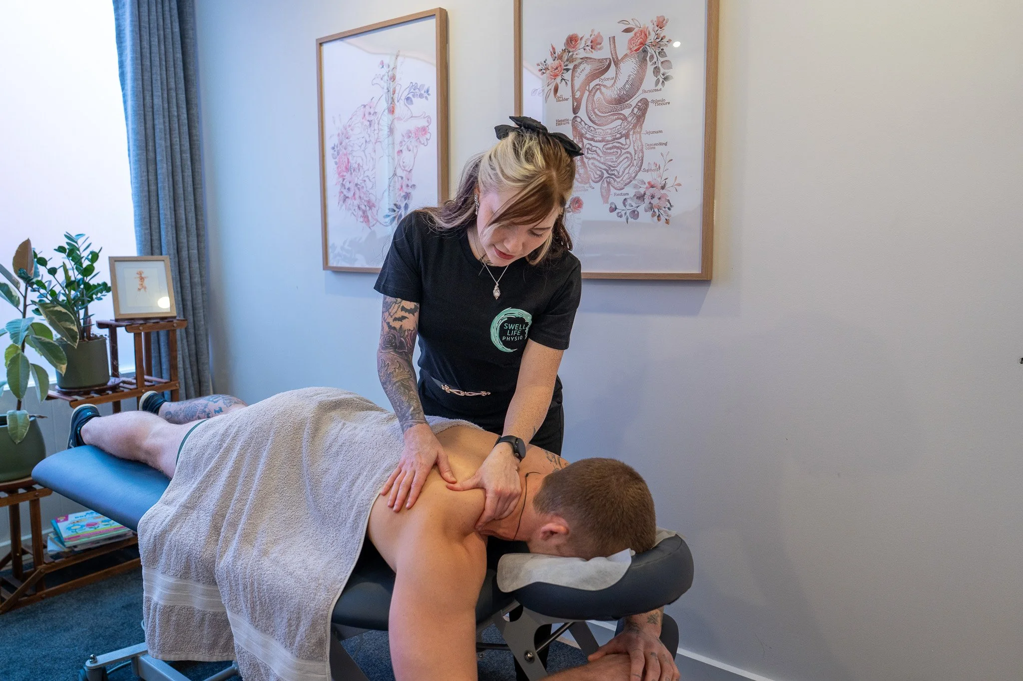 a female chiropractor treating a male client