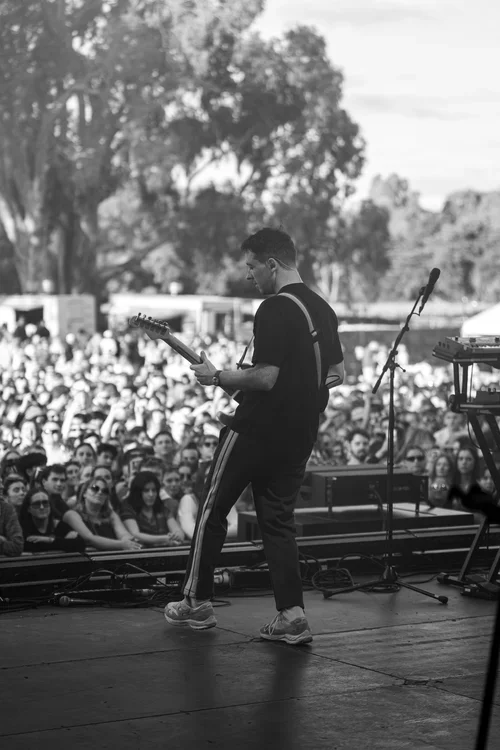 The Wombats frontman, Matthew "Murph" Murphy signing  and playing guitar in front of a large crowd at a music festival in McLaren Vale, South Australia