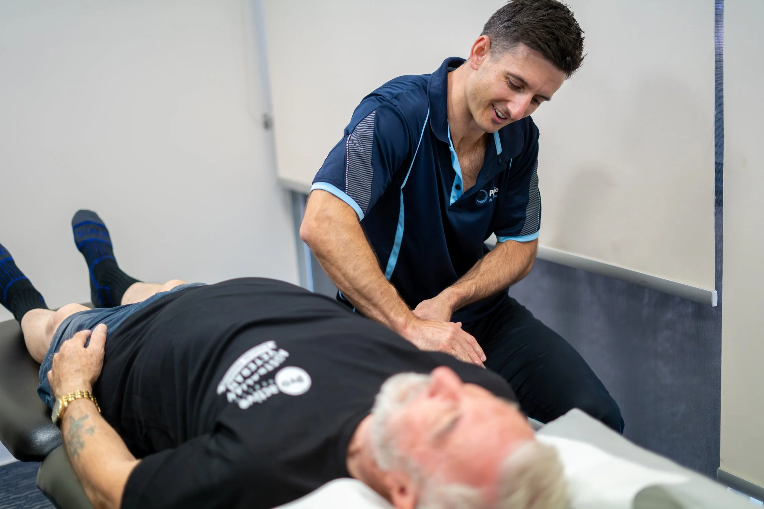 a male physiotherapist treating a male client