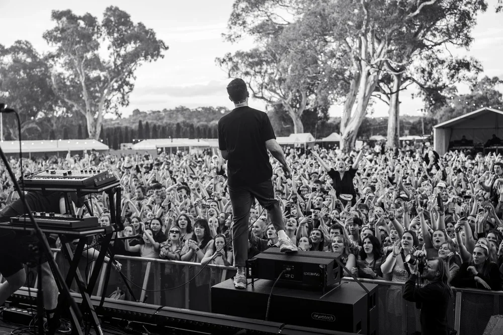The Wombats frontman, Matthew "Murph" Murphy signing  and playing guitar in front of a large crowd at a music festival in McLaren Vale, South Australia
