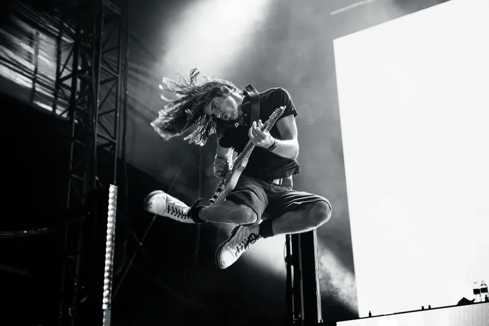 Spacey Jane guitarist jumping in the air at a music festival