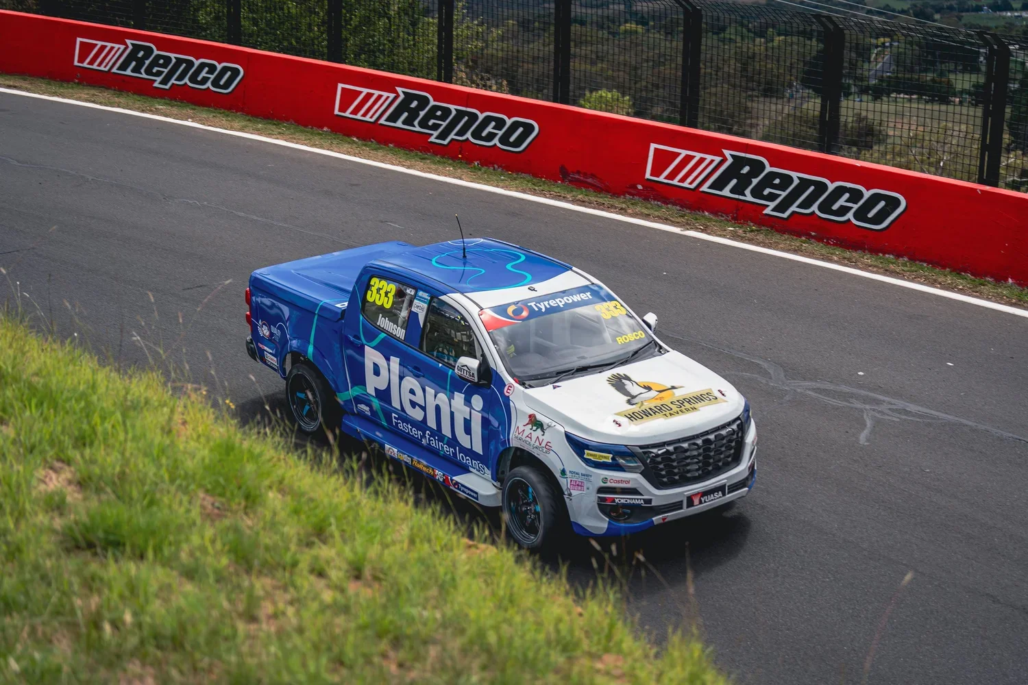 a V8 SuperUte Series race ute racing at a Bathurst race event.