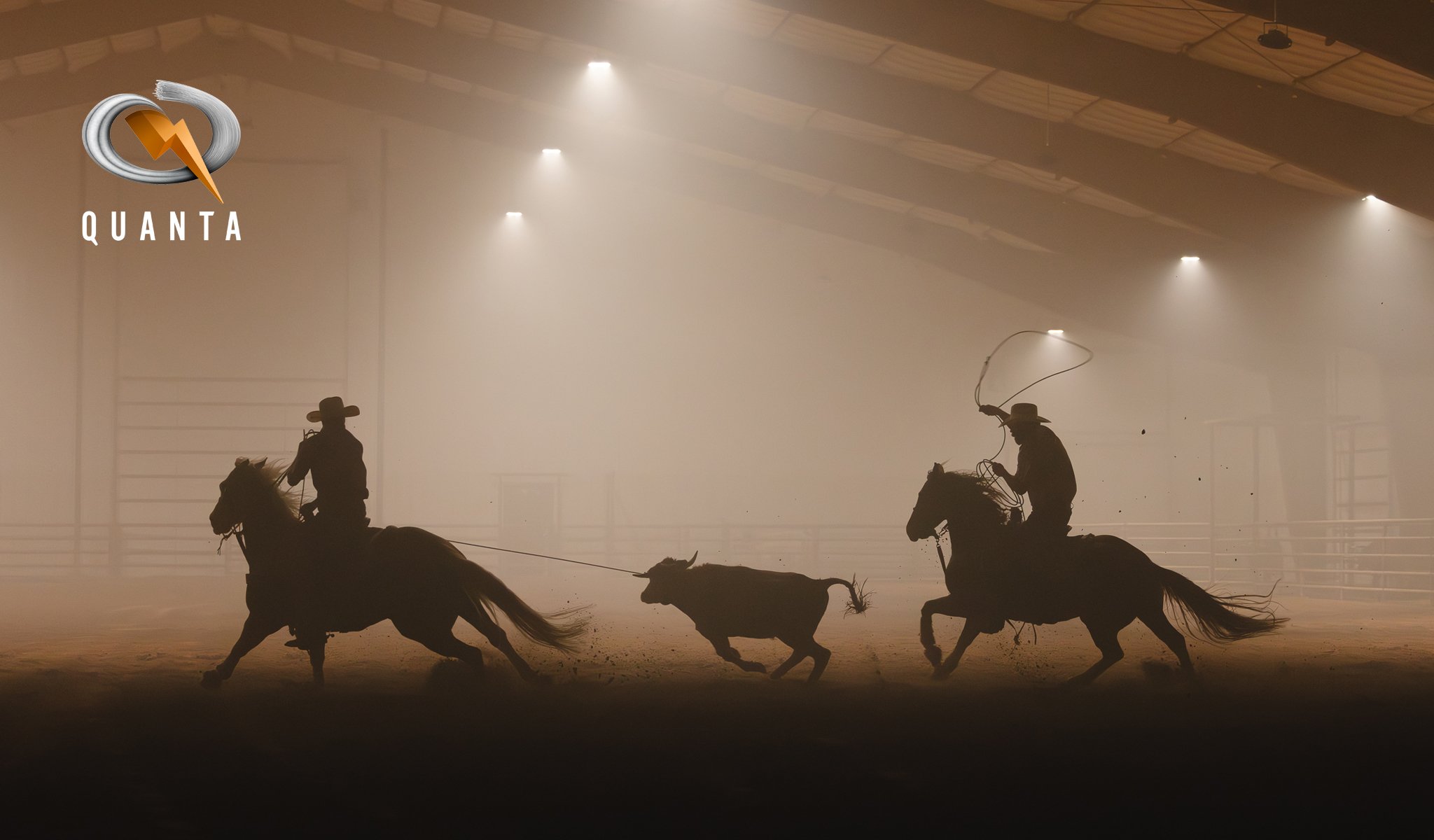 Silhouettes of two cowboys riding horses and a dog herding cattle inside a dusty indoor arena with overhead lights and a foggy atmosphere. The logo "QUANTA" is visible in the top left corner.