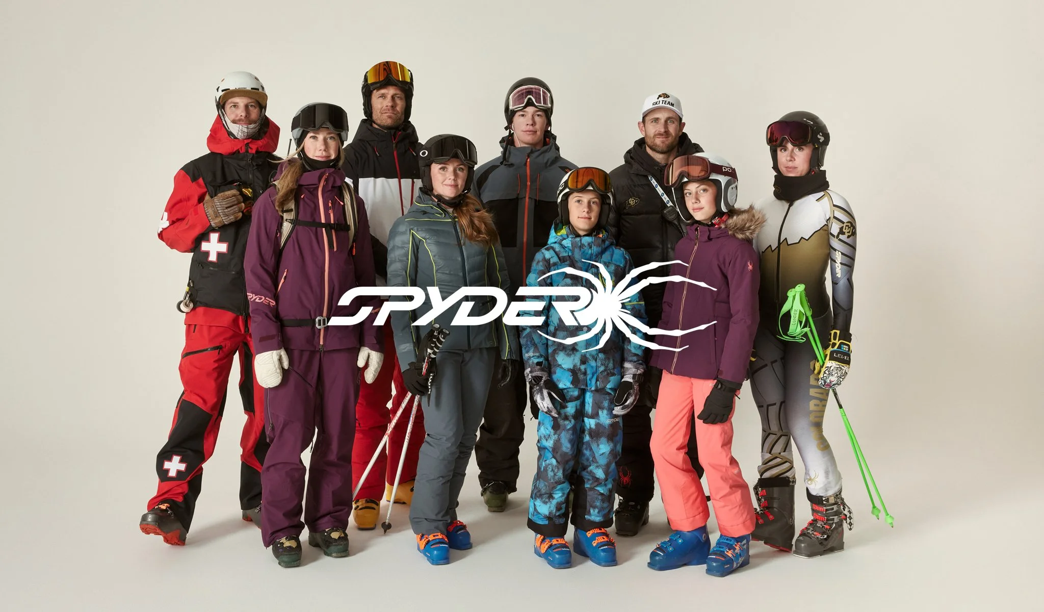 Group of nine people in ski gear, standing together in front of a plain white background, with the word "Ryder" and a snowflake logo overlaid on the front.