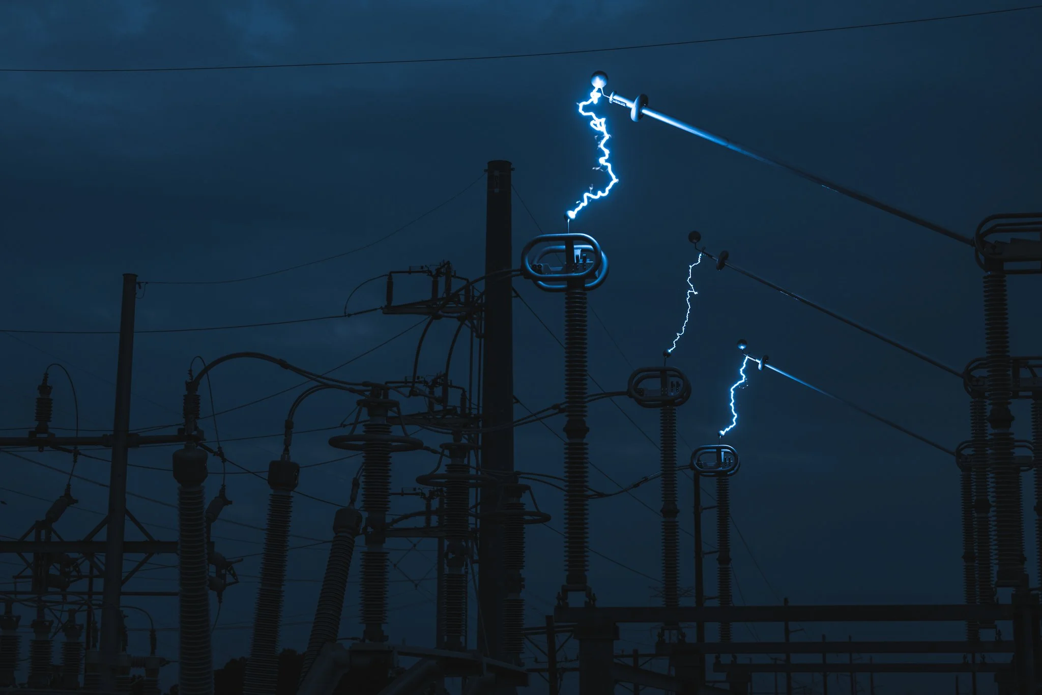 Electrical power lines and transformers with lightning in the dark stormy sky
