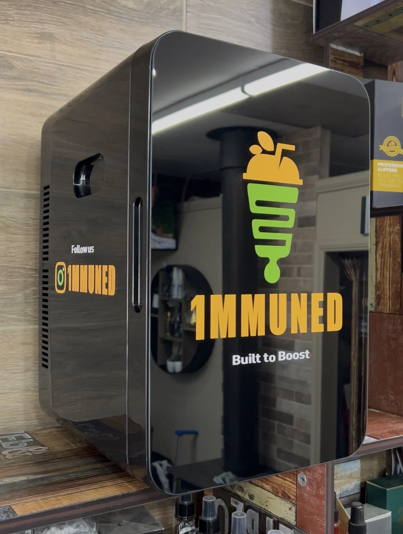 1MMUNED-branded drinks fridge displayed in barber shop