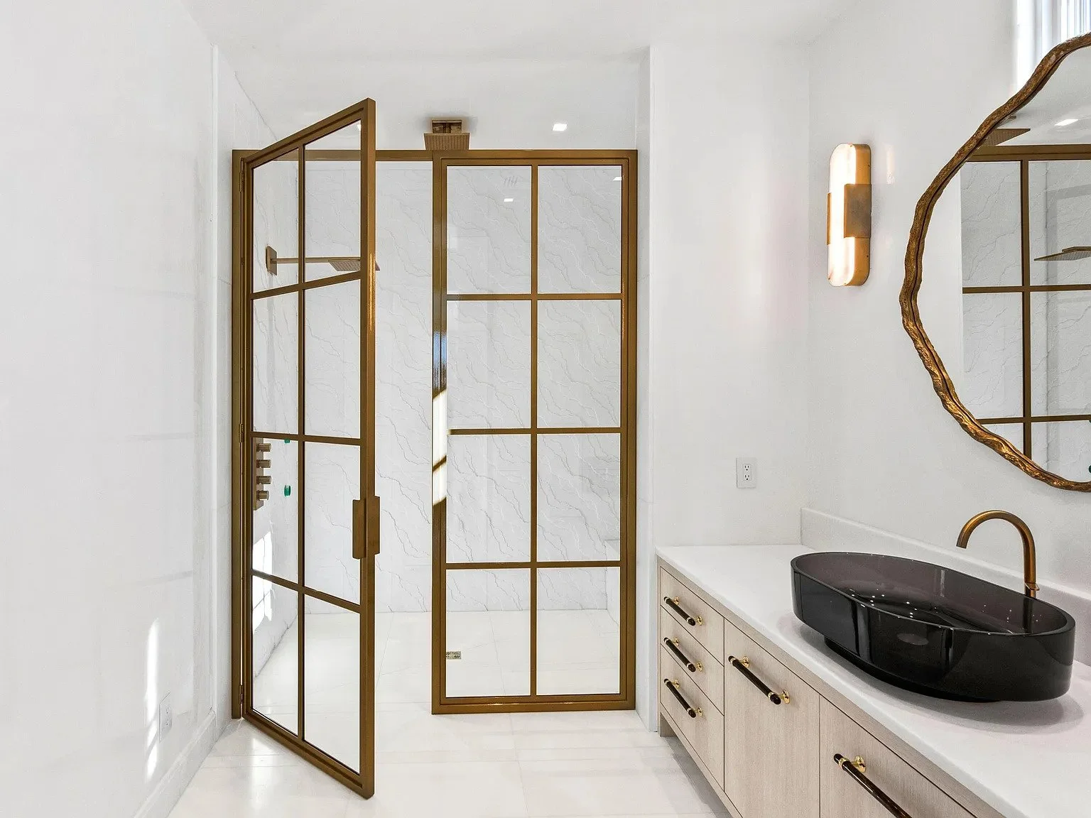 044-guest-bath-gold-frame-shower-organic-mirror.jpg