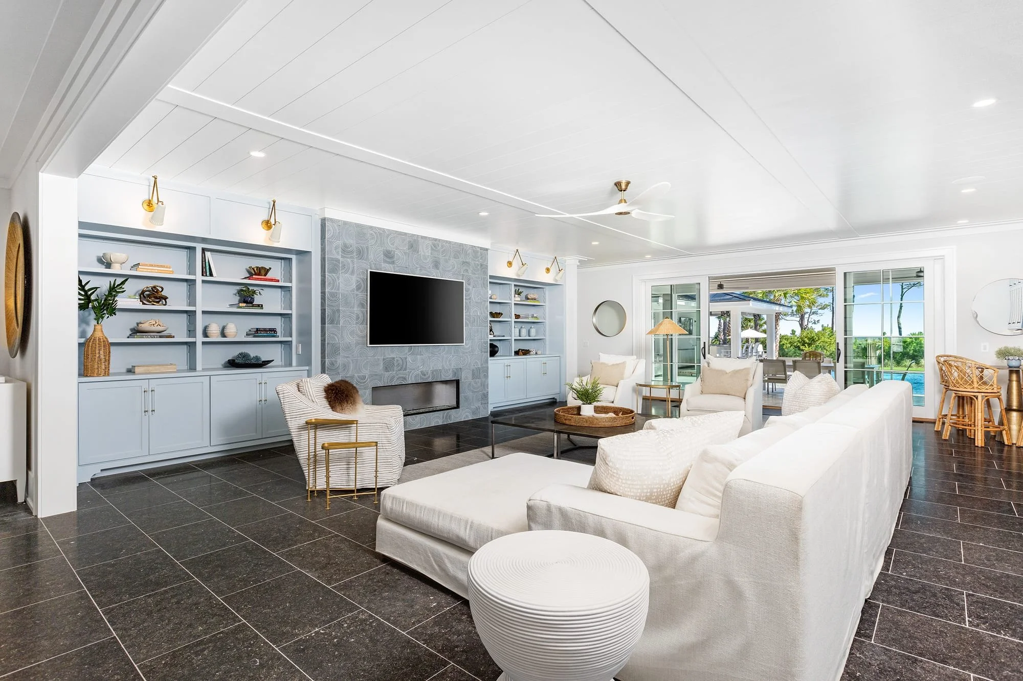 029-lower-great-room-blue-builtins-pool-view.jpg