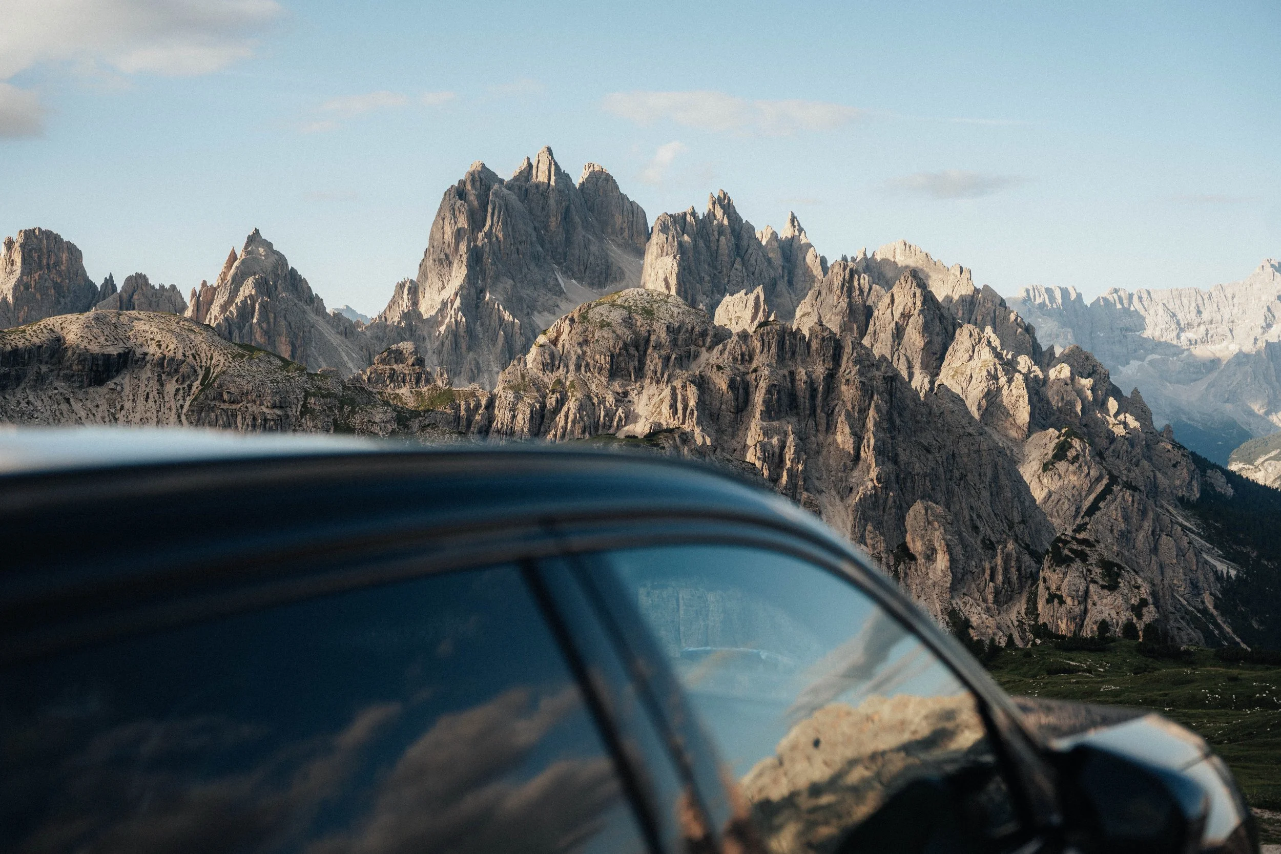 Mountain landscape seen through the window of a parked car.