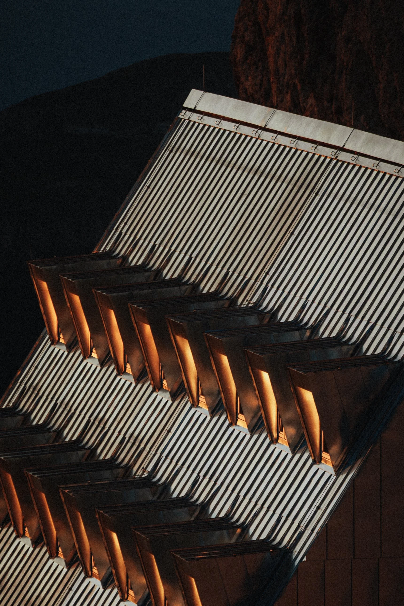 Close-up of a digital piano with illuminated keys at night.