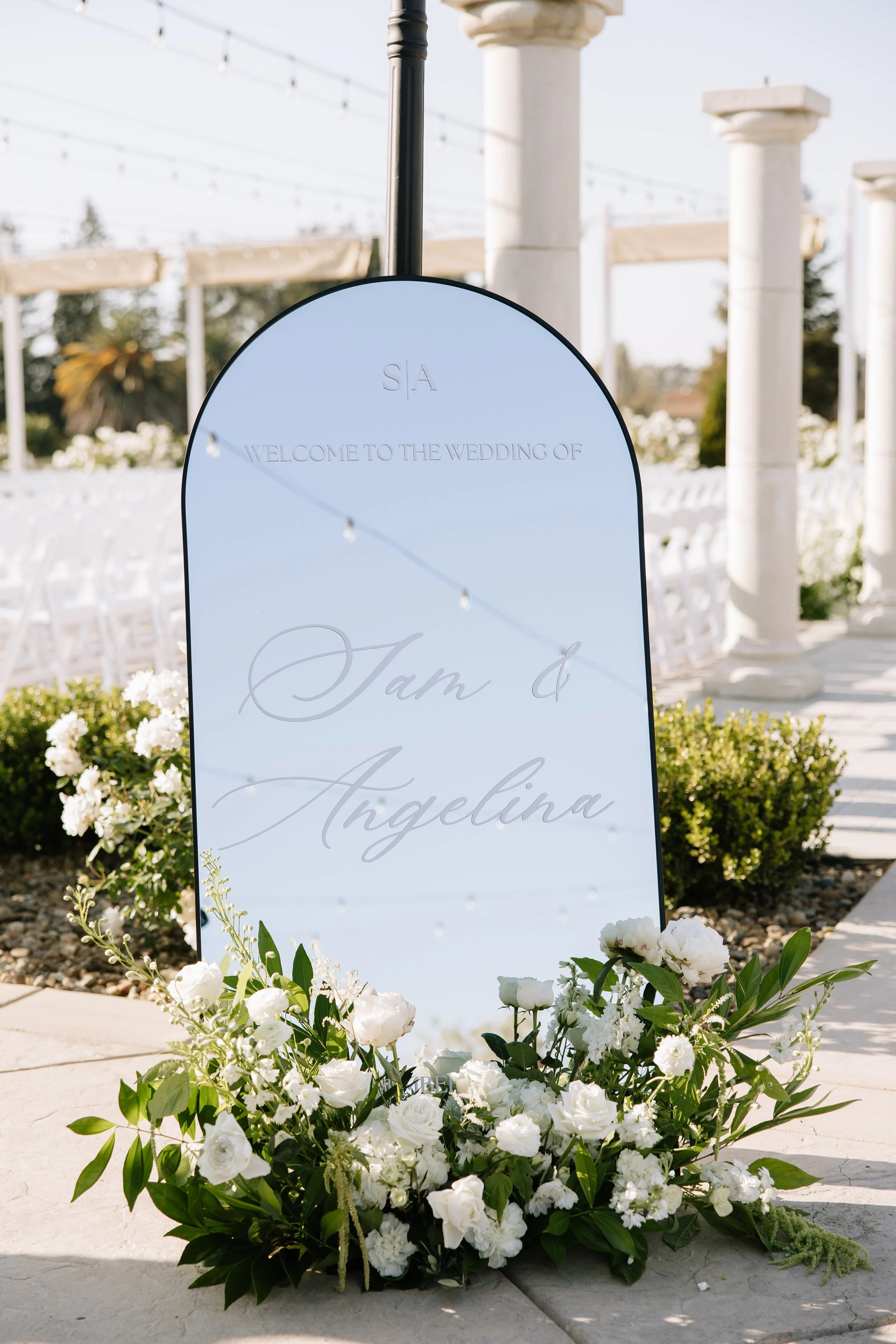 Wedding welcome sign with florals showcasing signature tone design, company branding, local embroidery details, and a quick timeline for event signage