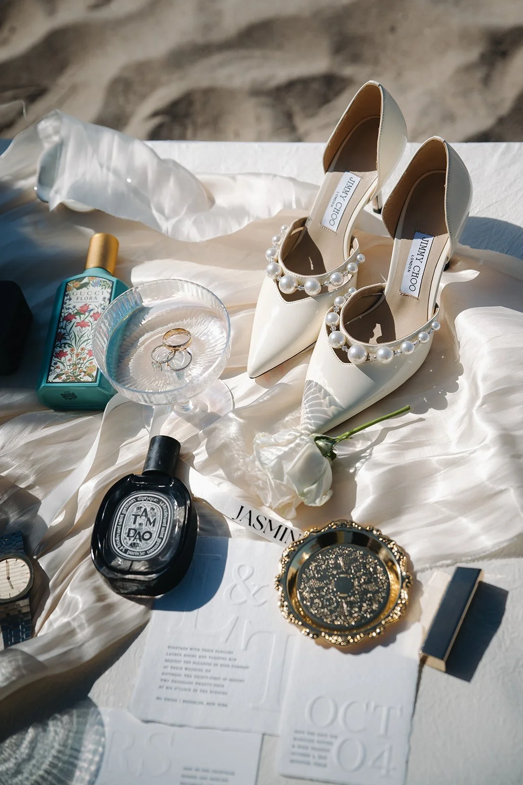 Wedding detail flat lay reflecting signature tone styling, company branding, local embroidery accents, and a quick timeline for custom wedding details