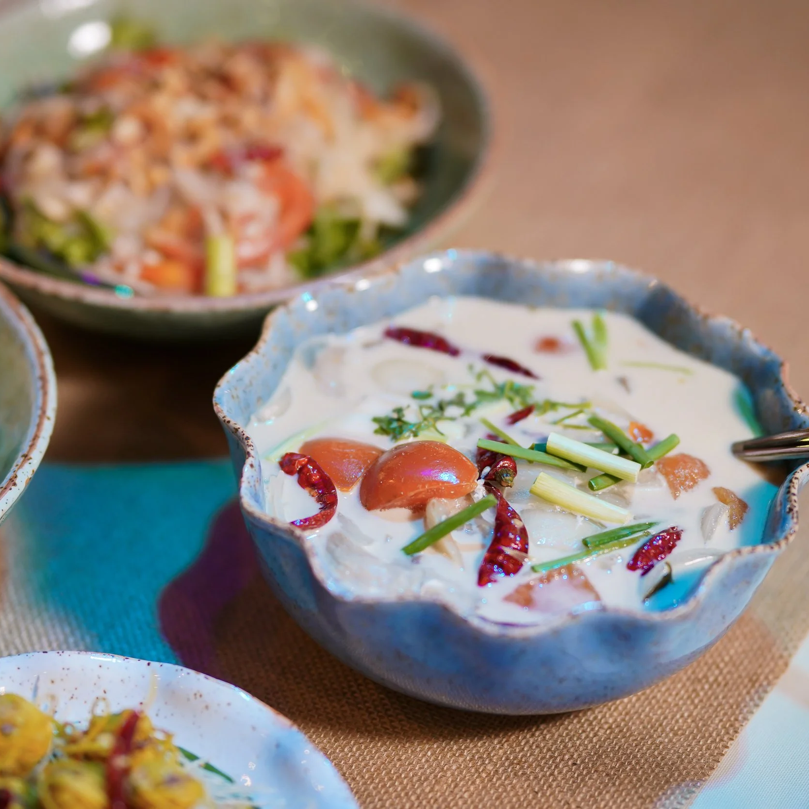 A bowl of Thai green mango salad with cherry tomatoes and herbs. Private dining best villa Phuket