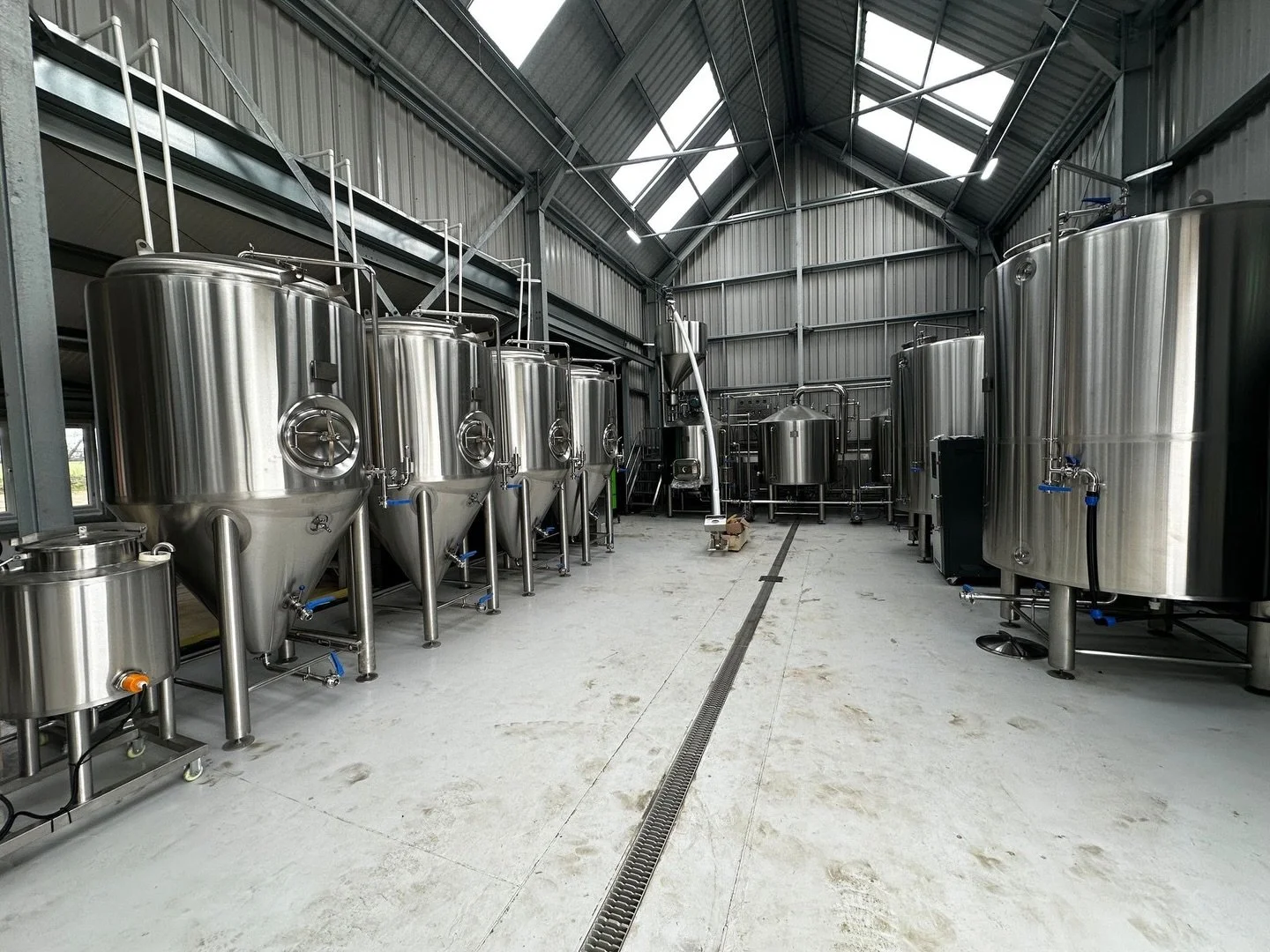 It&rsquo;s starting to look like a working brewery.

Mill.
Auger.
Brewhouse.
Fermenters.

The flow is coming together &mdash; grain in one end, beer out the other.

We&rsquo;re getting closer to running product through the system instead of just cabl