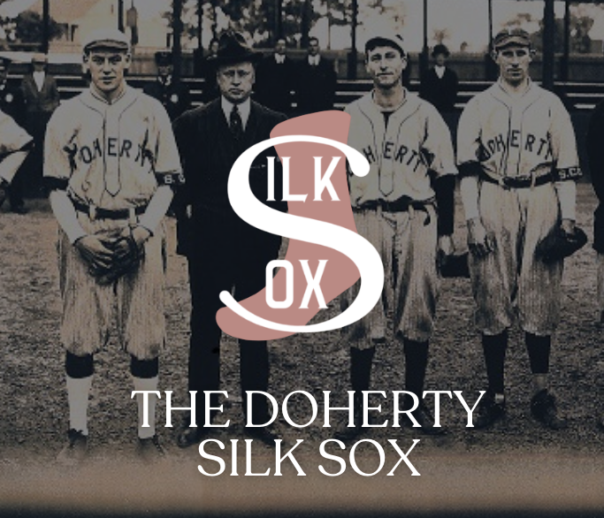 Historical black and white photograph of a baseball team with four players in uniforms and two men in suits standing on a baseball field, with a logo overlay reading 'ILK SOCK' and text 'The Doherty Silk Sox'.