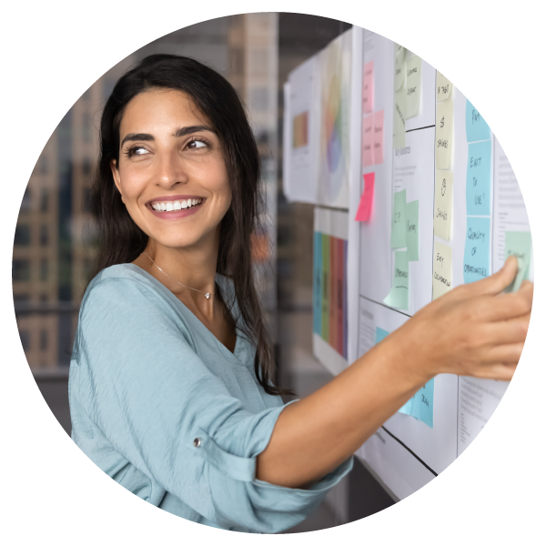 Female project manager reviewing project plans on a whiteboard