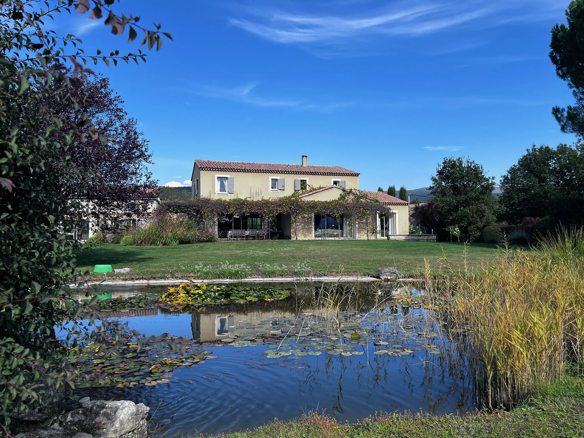 Front view of the property and the pond