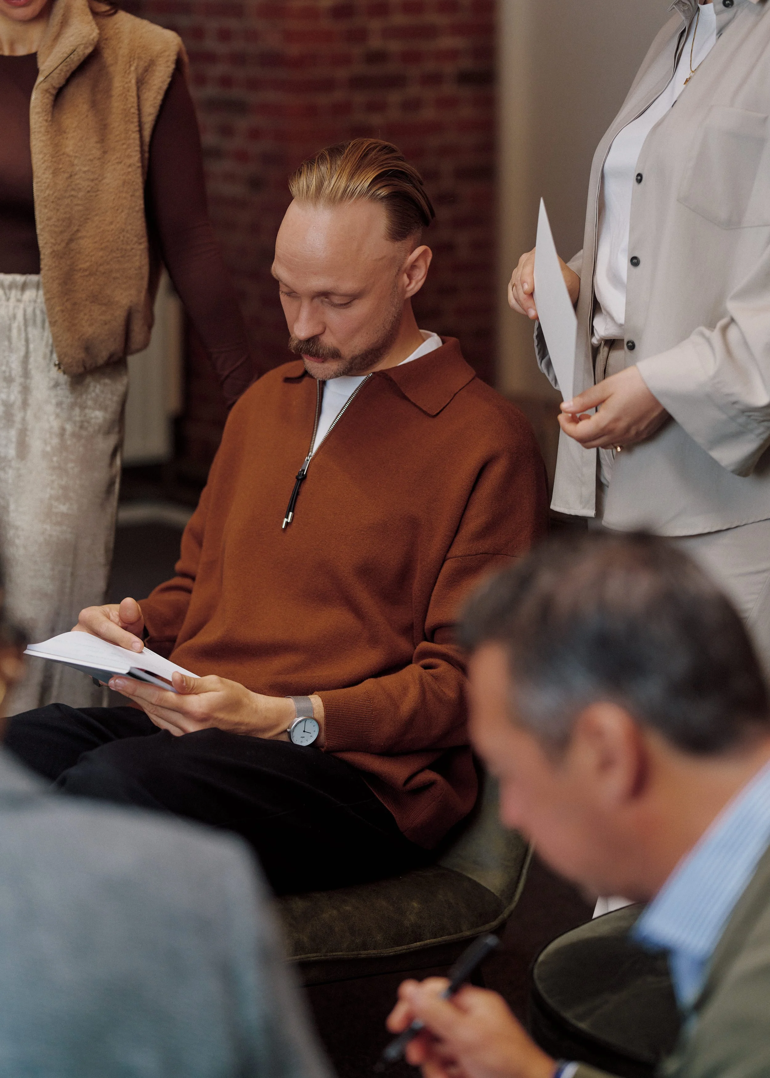 Four CEOs together taking notes at a workshop session.