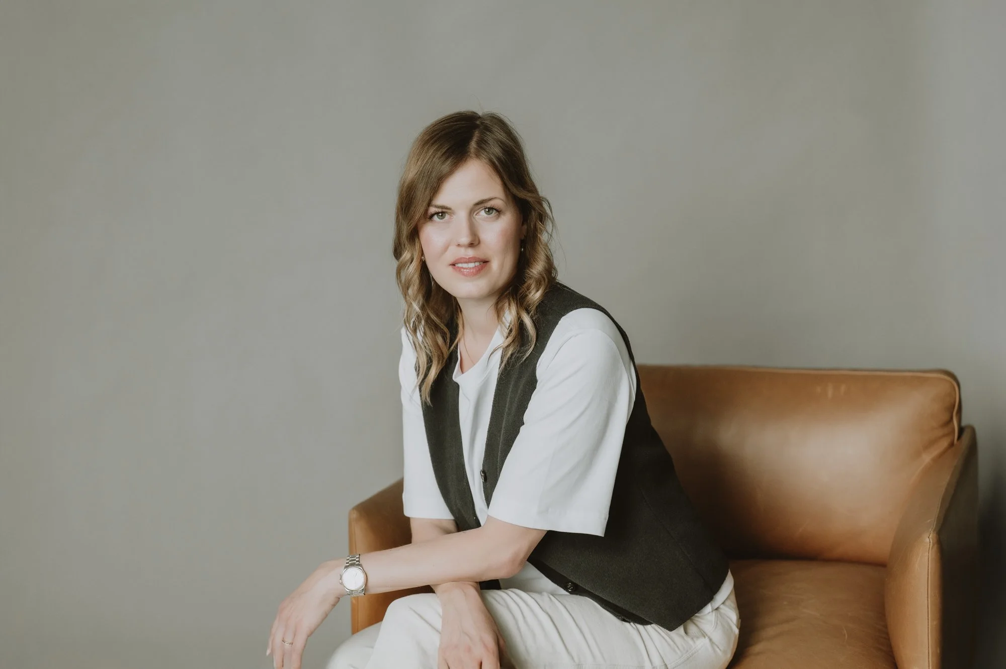 Coach auf einem Ledersessel in einem Zürcher Co-Working-Space mit direktem Blick in die Kamera.