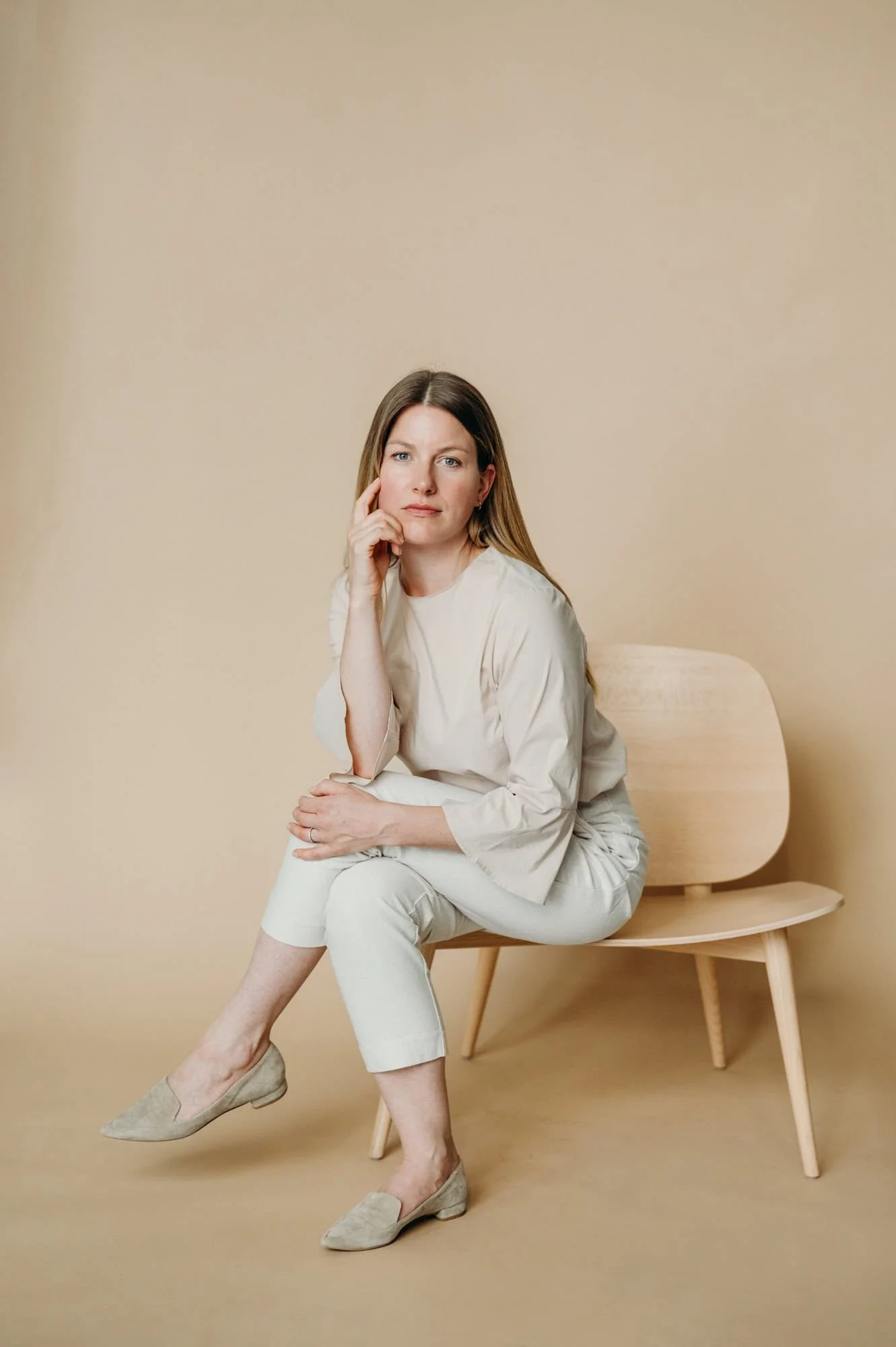 Woman sitting relaxed on chair for business portrait