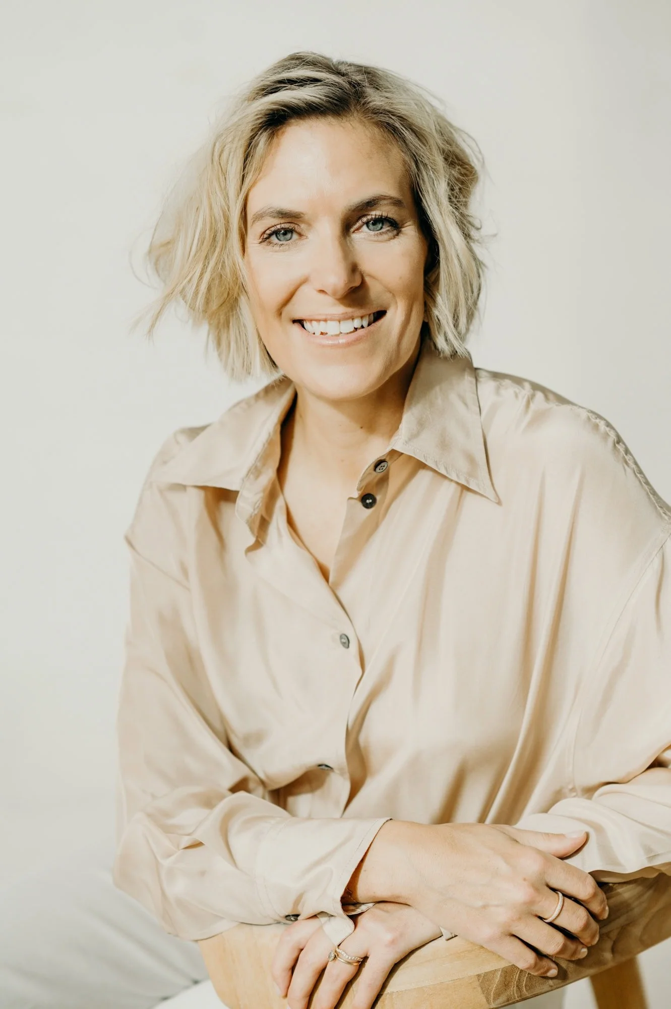 Female founder smiling into camera, relaxed and natural in business portrait
