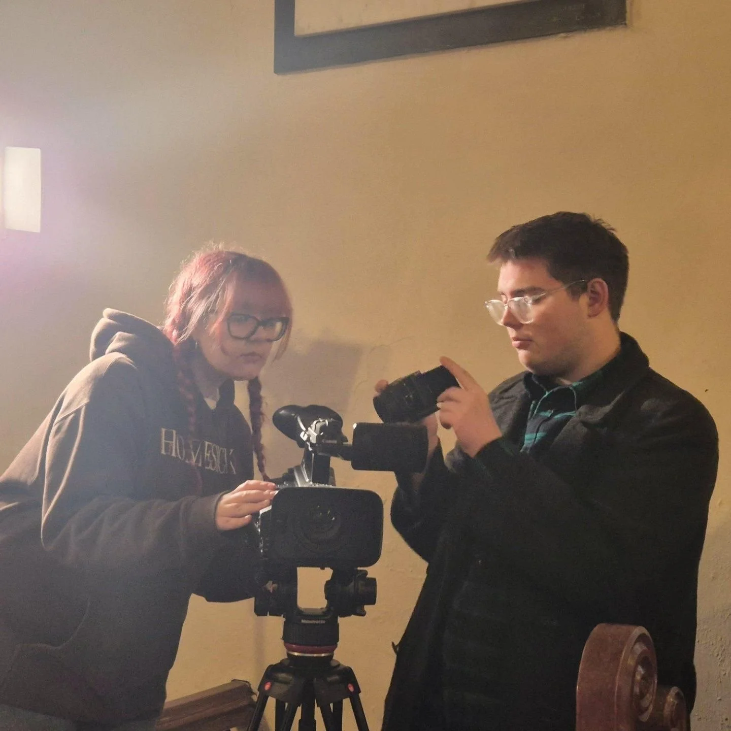 Two film-makers checking the camera setup is ready to go