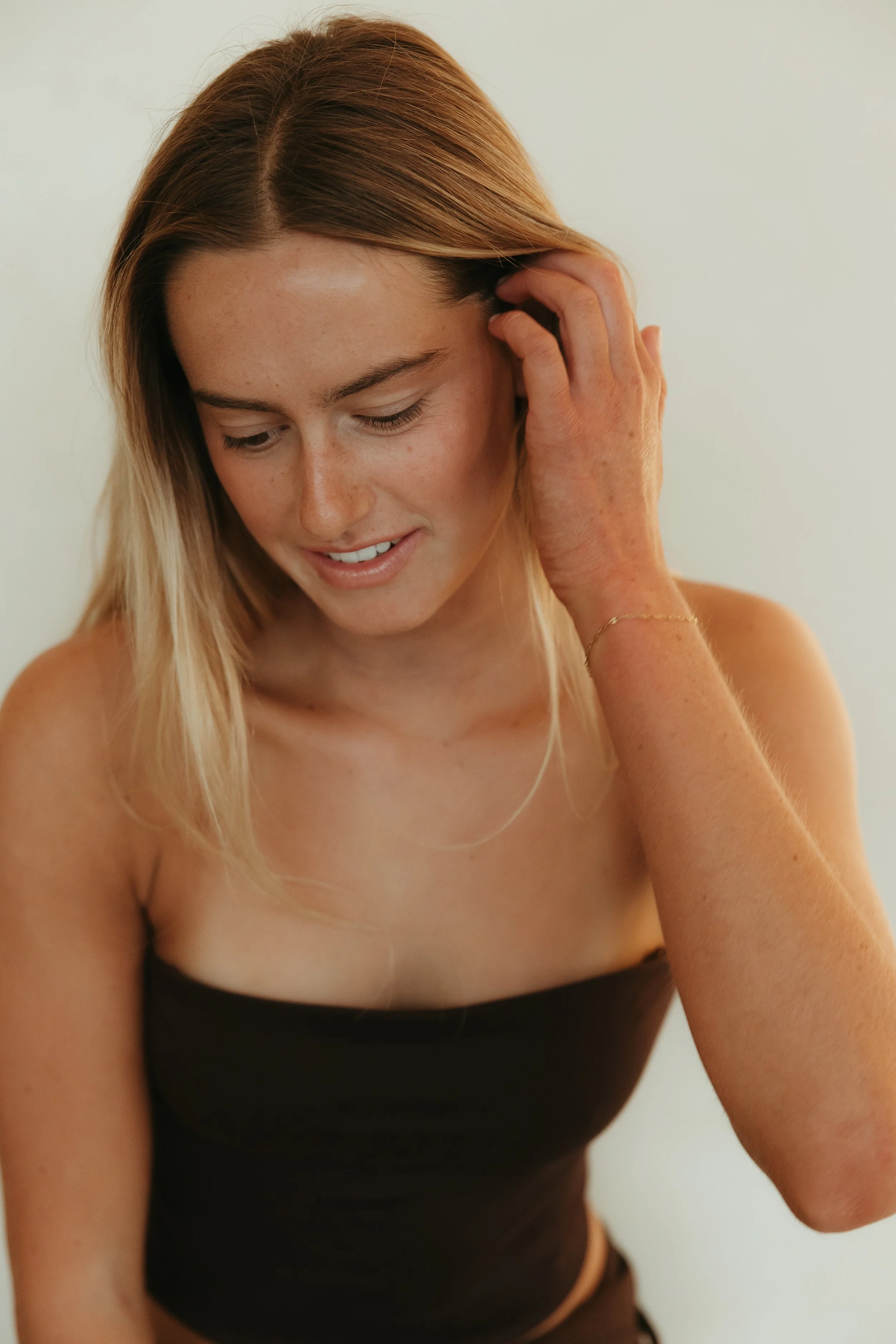 Close-up of a person's shoulder and upper back, with smooth skin and soft lighting.