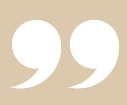 Two large white quotation marks on a beige background.