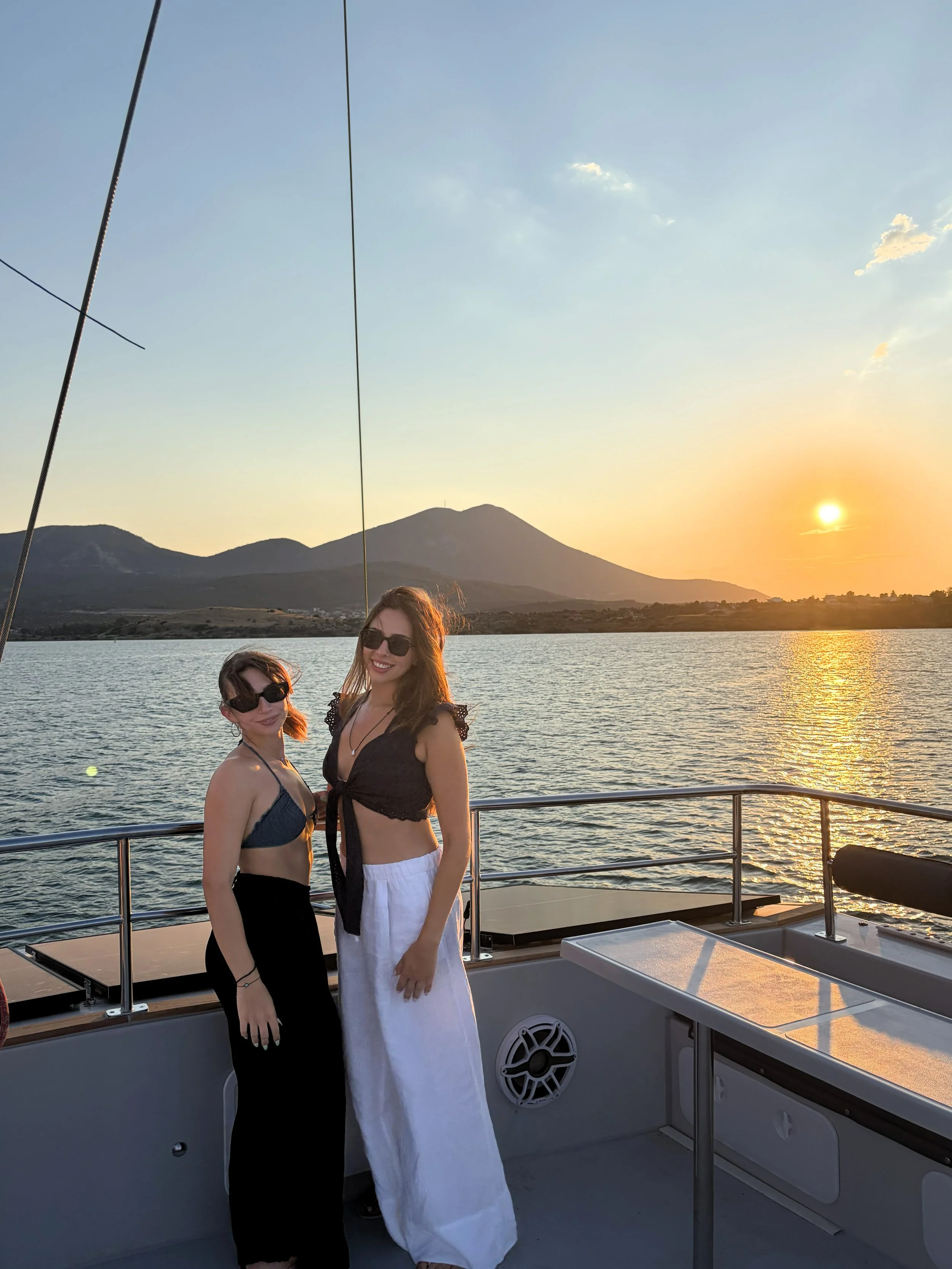 Two women smiling on a catamaran.