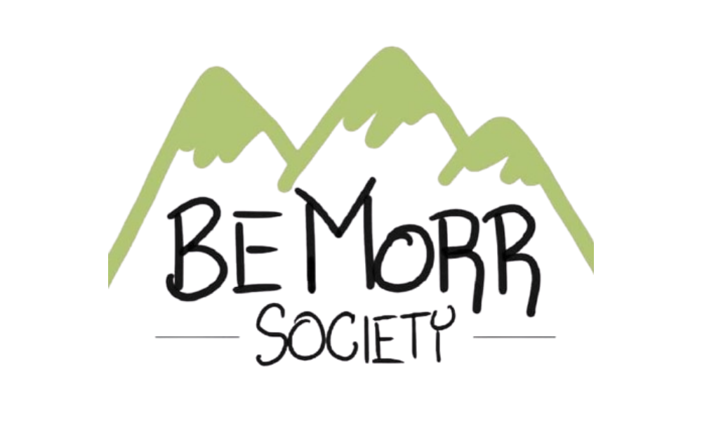 Hand-drawn logo of a mountain range with the text 'Be More Society' underneath.
