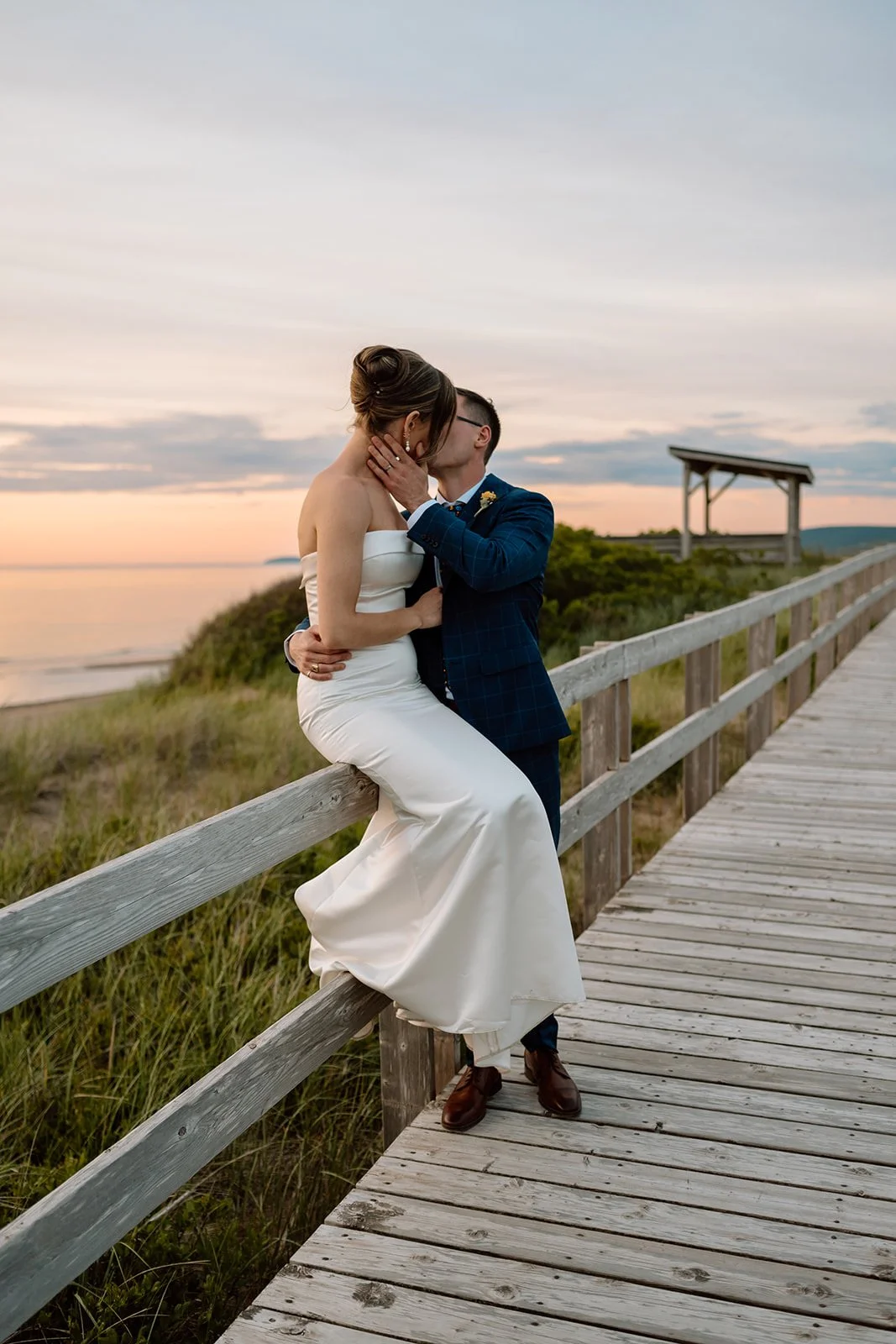 Laurie’s customers, Mariana and Carmen holding hands on a green lawn on their wedding day.