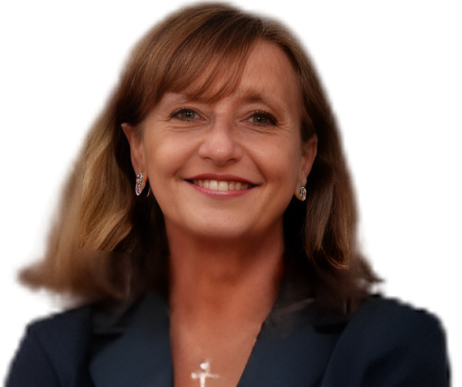 A woman with brown hair smiling, wearing earrings, a navy blazer, and a cross necklace, against a white background.