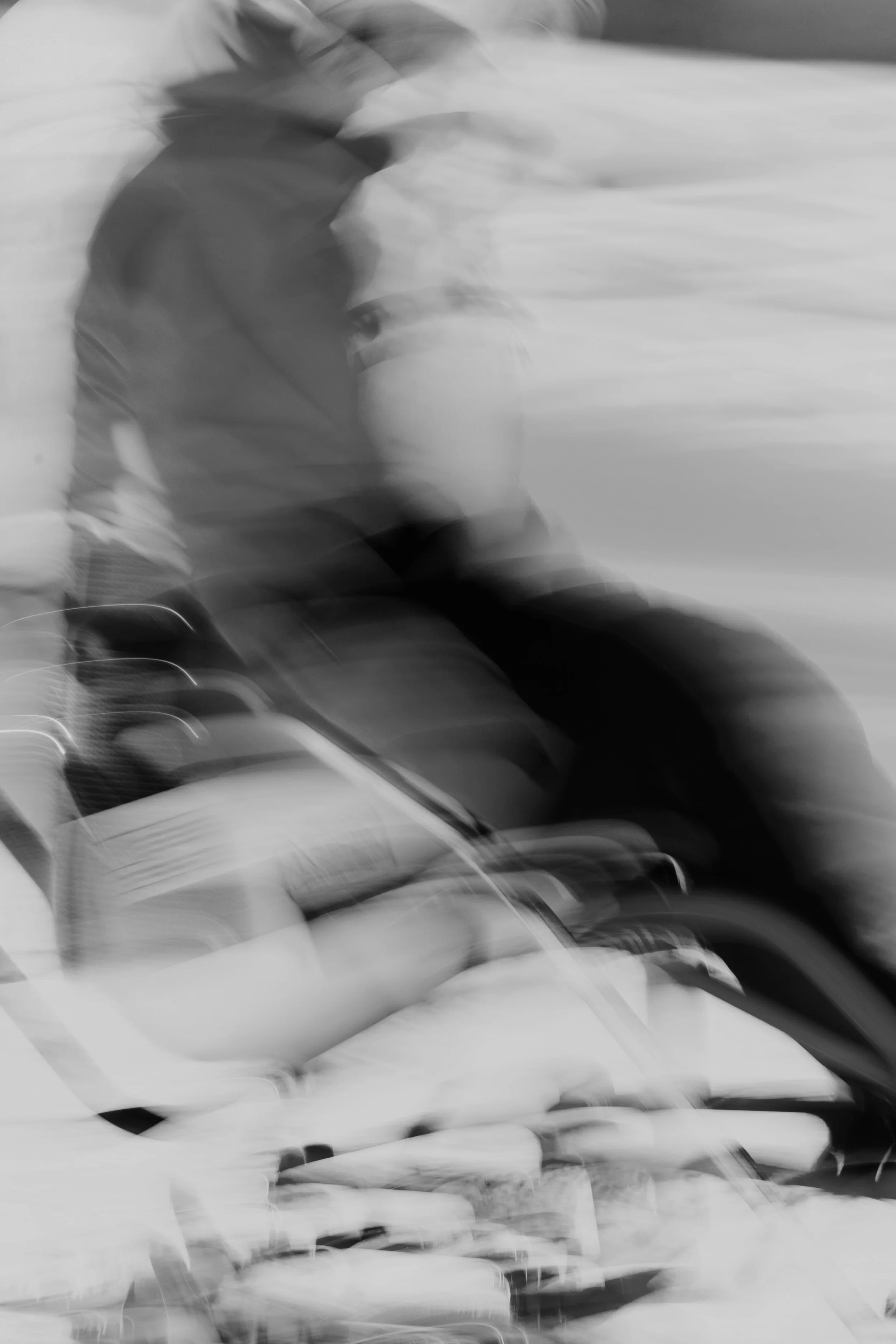 A black and white image of an adaptive skier.