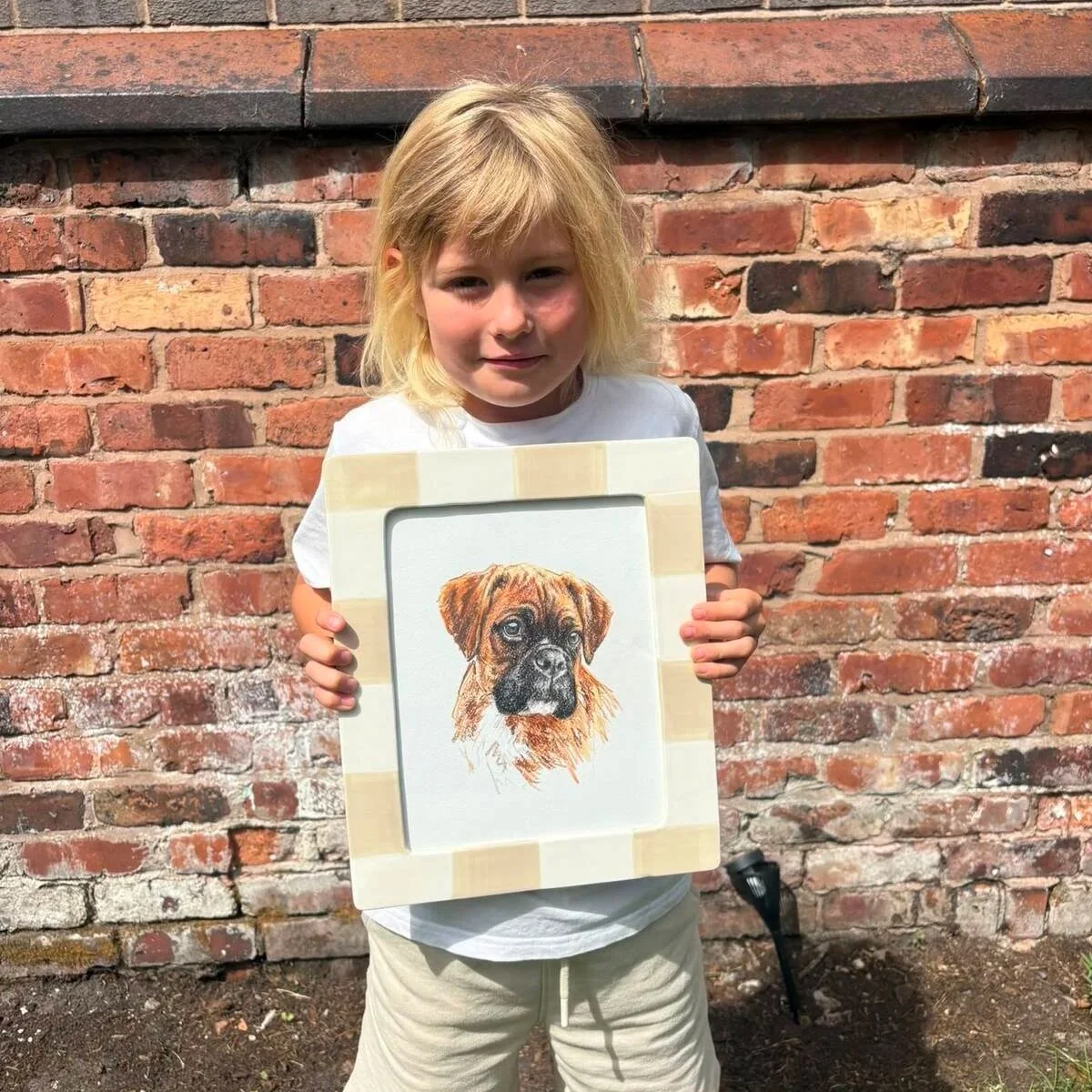 Mabel holding her custom pet portrait of boxer dog
