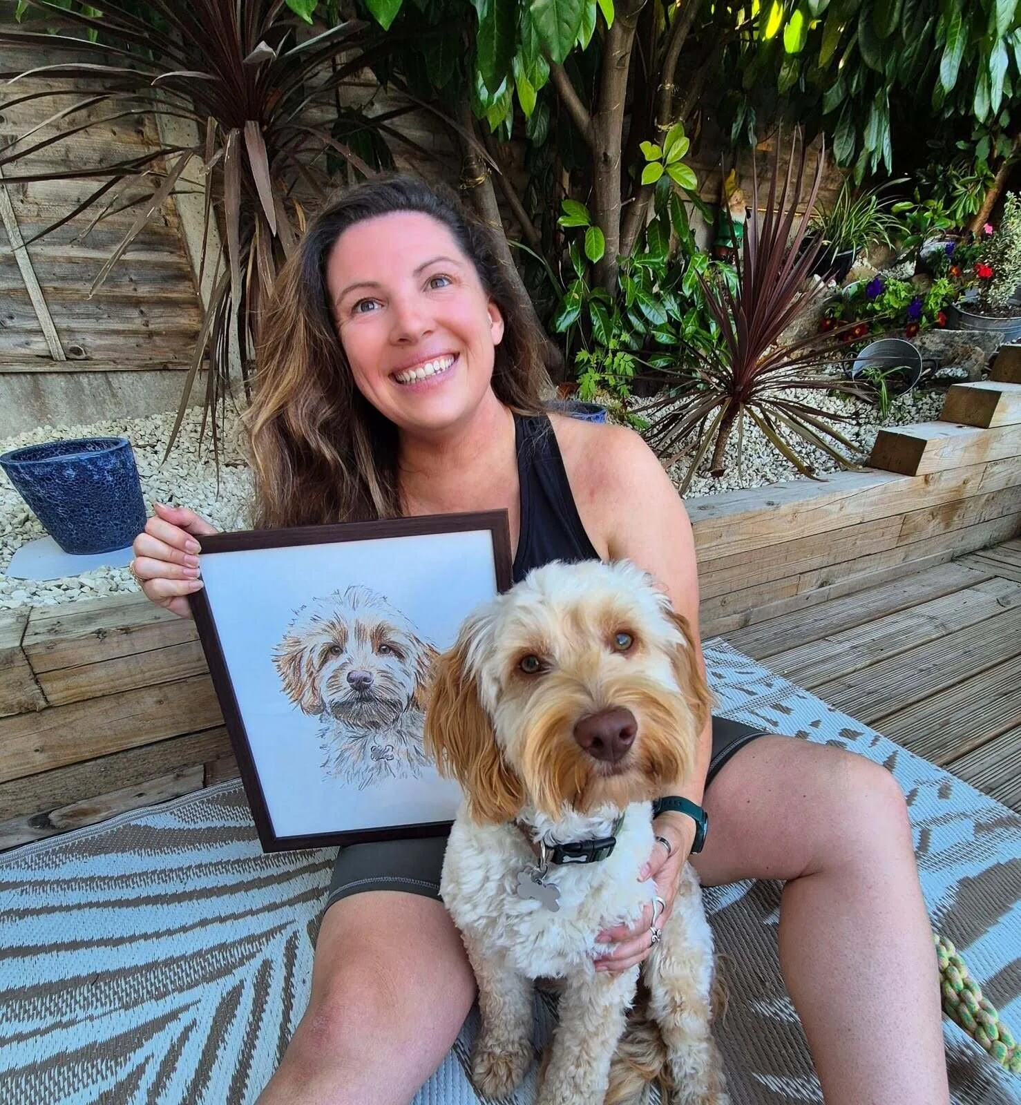 Emma and Maverick next to their custom hand drawn pet portrait