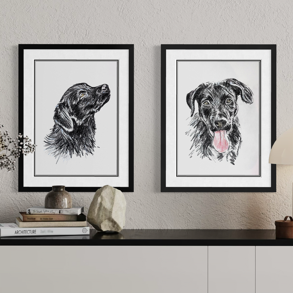Two framed black dog portraits shown as pet wall art in a home setting by Jonny Atkinson
