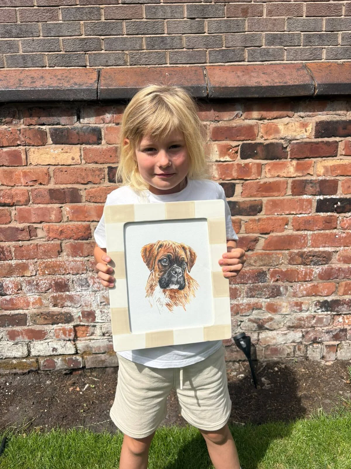 Mabel holding her custom pet portrait of boxer dog