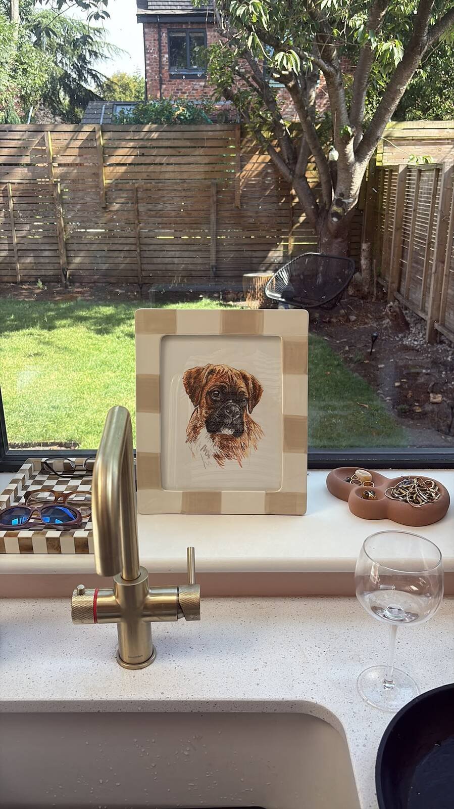 Custom pet portrait in frame on kitchen windowsill